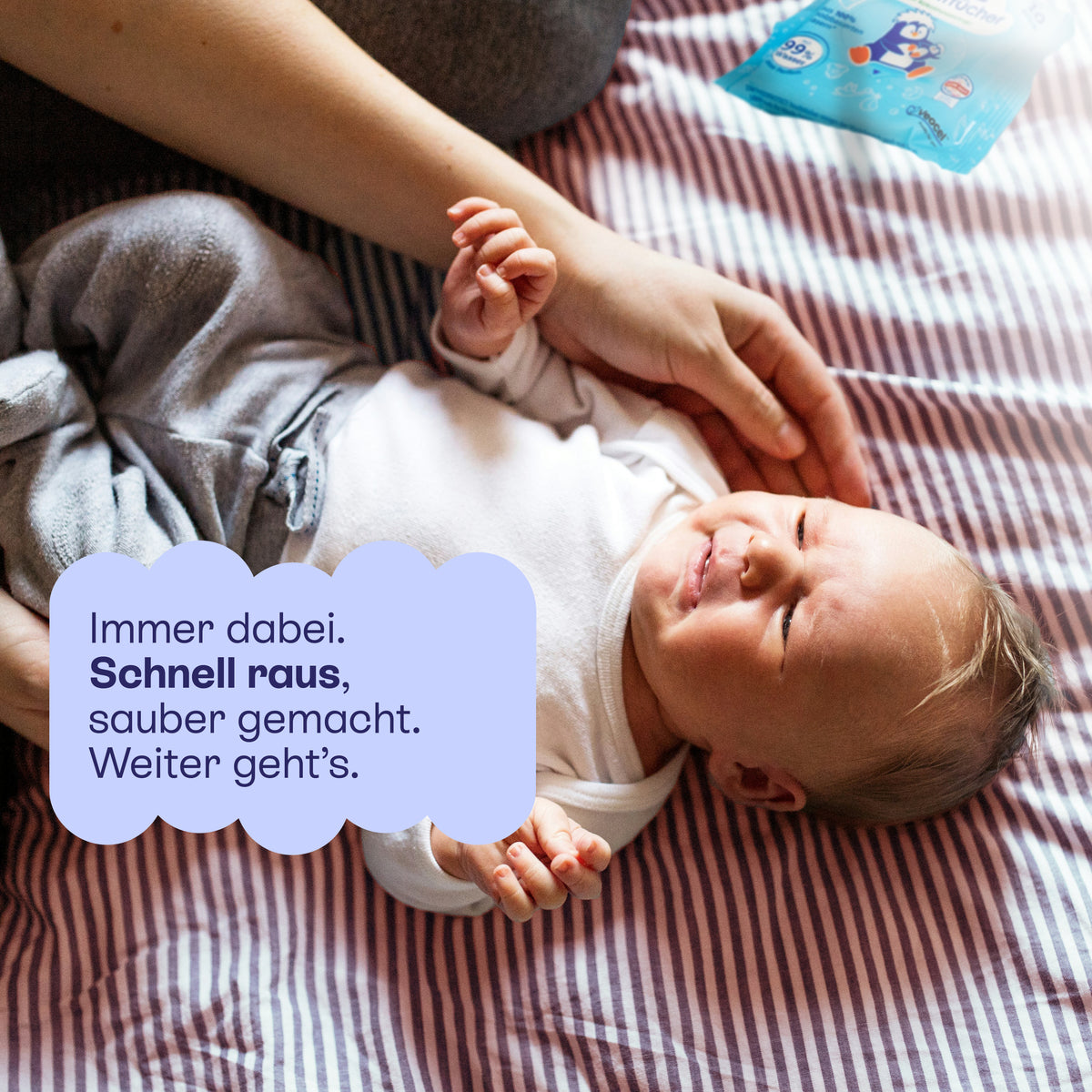 Baby auf einer Decke wird mit einem Feuchttuch abgewischt: schnell raus, sauber gemacht, weiter geht's.