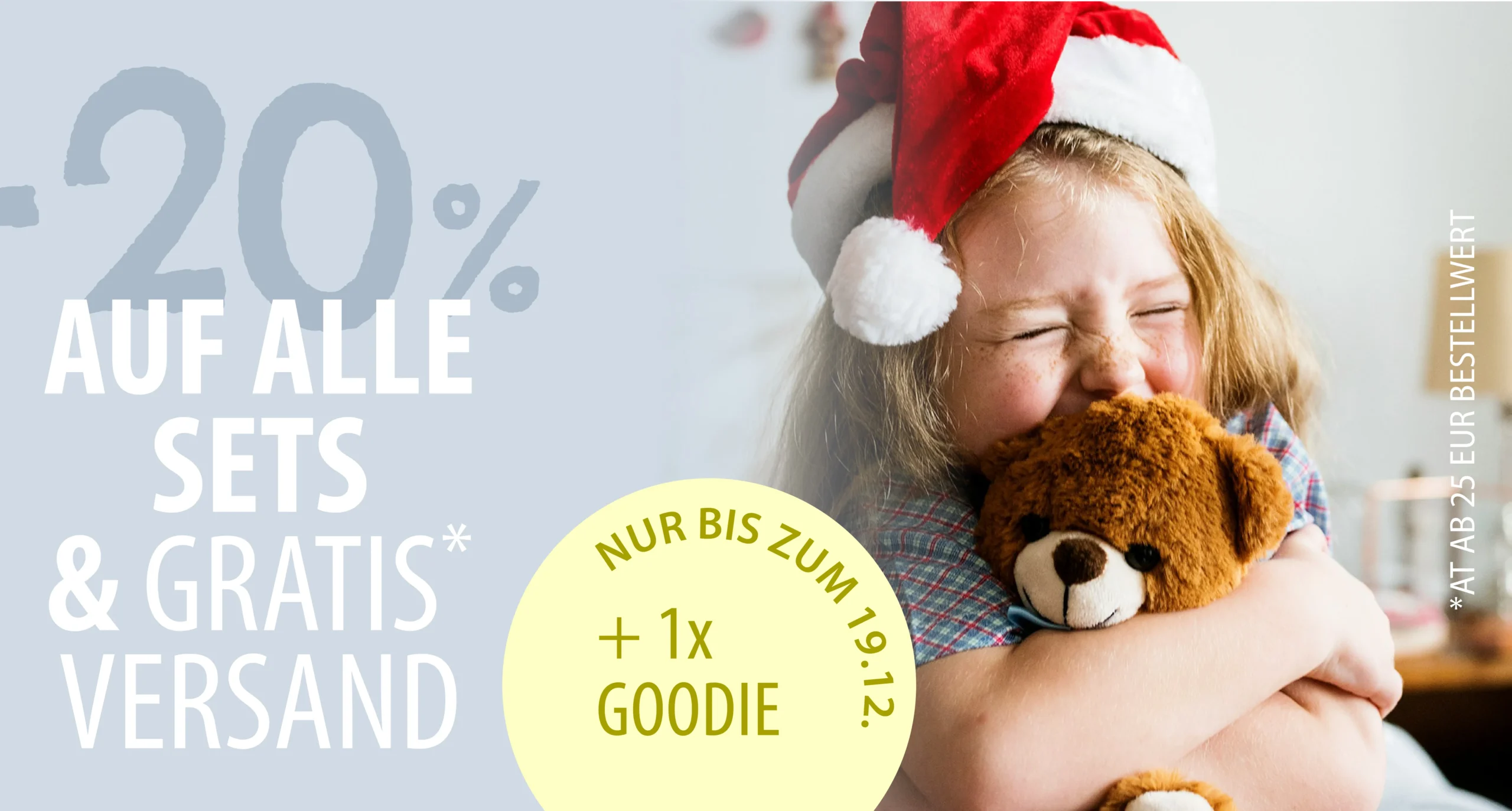 a girl in a santa hat hugging a stuffed animal