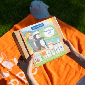 a person holding a bottle of sunscreen