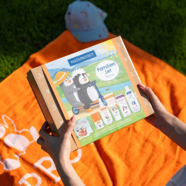 a person holding a bottle of sunscreen