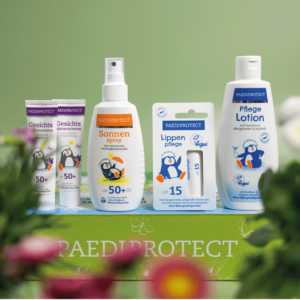 a group of bottles of baby lotion an sunscreen