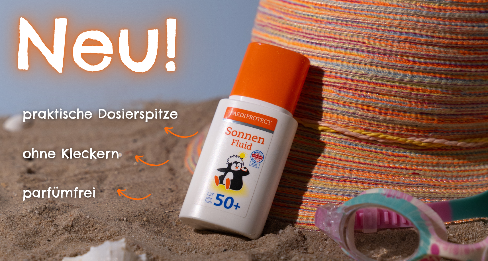 a bottle of sun protection on sand