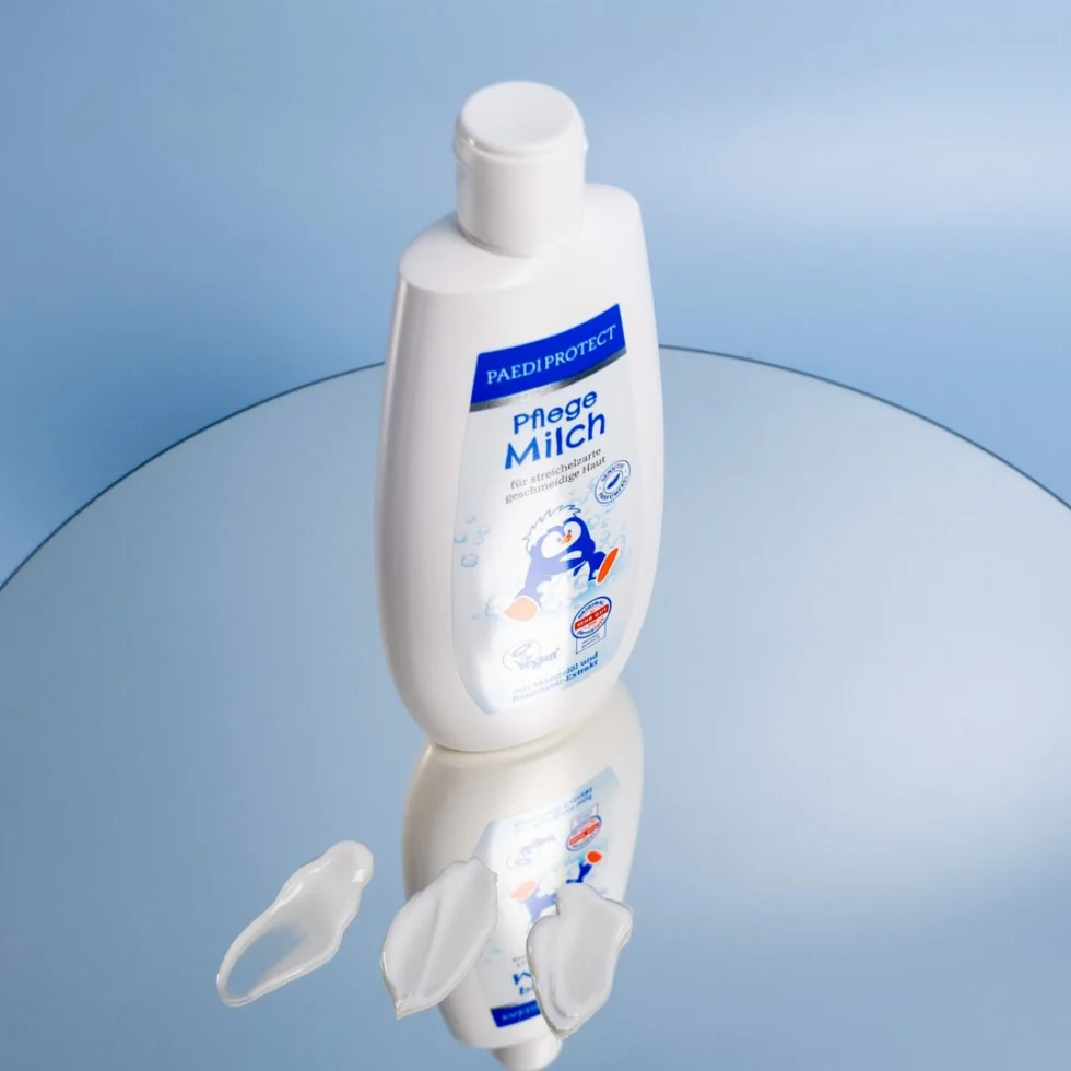 a bottle of milk on a mirror surface