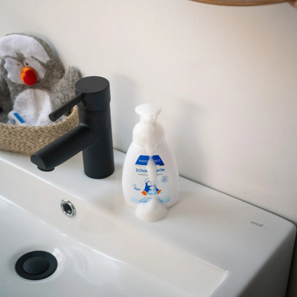 a sink with a black faucet and a black faucet and a black sink with a black faucet and a black faucet and a black faucet with a white