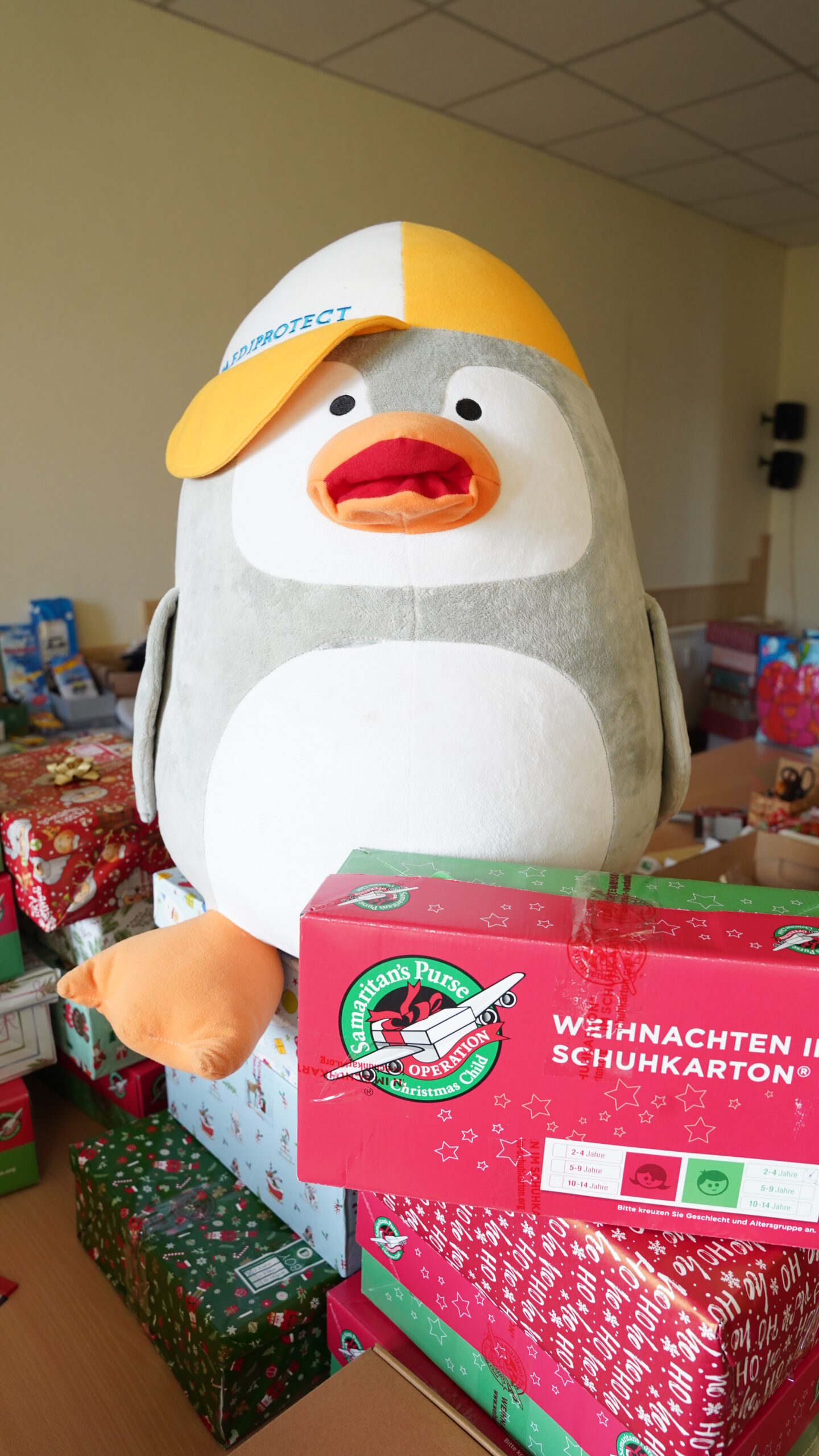 a stuffed penguin with a yellow hat