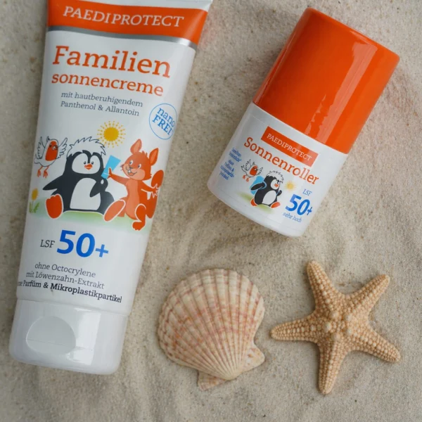 Sonnencreme und Sonnenschutz auf Sand